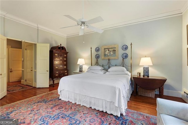 bedroom with baseboards, crown molding, a ceiling fan, and wood finished floors