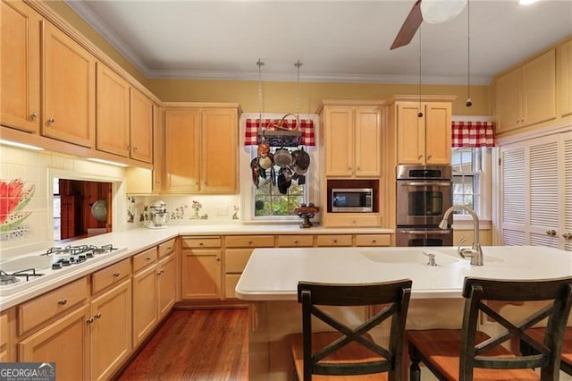 kitchen with backsplash, a breakfast bar area, light countertops, dark wood-style floors, and stainless steel appliances