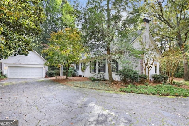 view of front of home with driveway and a chimney