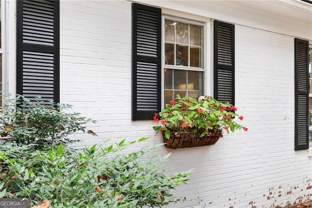 exterior space with brick siding