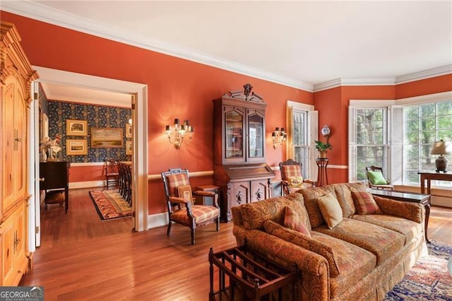 living area featuring baseboards, wood finished floors, and ornamental molding