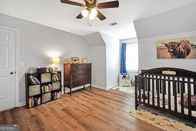 bedroom with visible vents, ceiling fan, baseboards, and wood finished floors