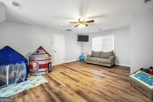 playroom with baseboards, visible vents, and wood finished floors