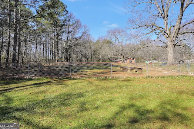 view of yard with a rural view and fence