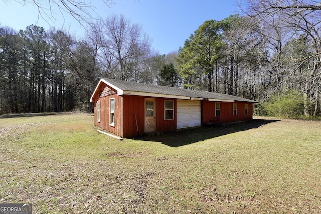 view of outdoor structure with a garage and an outbuilding