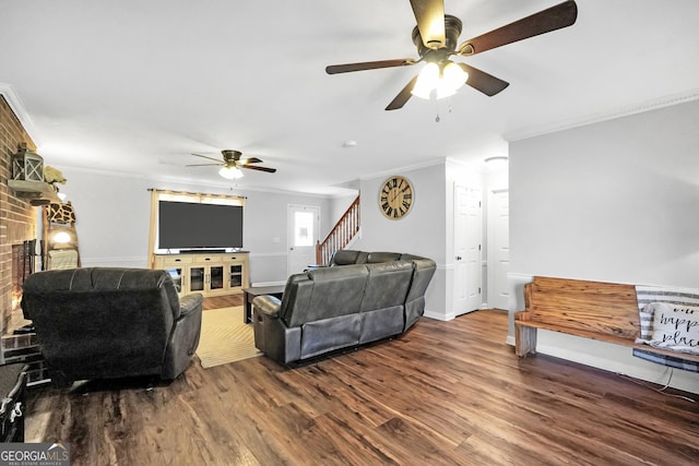 living area with a fireplace, ornamental molding, wood finished floors, baseboards, and stairs