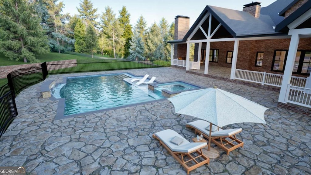 view of swimming pool featuring a patio area, a pool with connected hot tub, fence, and a lawn