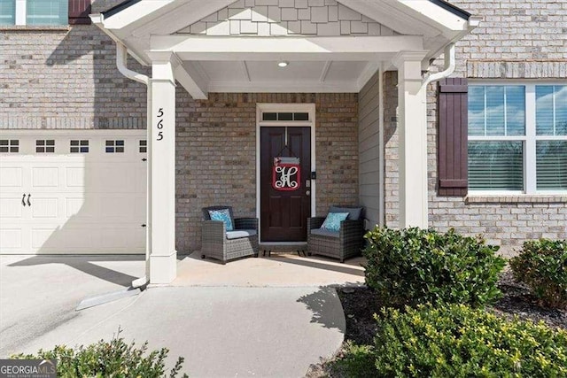 property entrance featuring brick siding and an attached garage