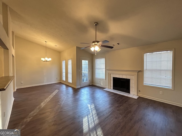 unfurnished living room with dark wood finished floors, visible vents, vaulted ceiling, and a tiled fireplace