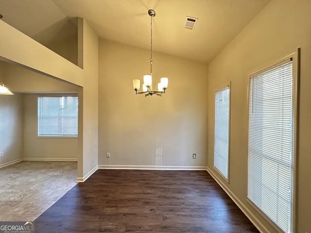 unfurnished dining area with lofted ceiling, dark wood finished floors, a chandelier, and visible vents