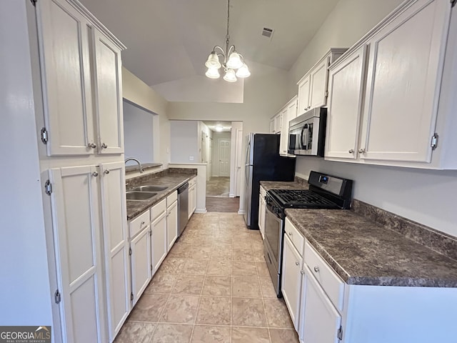 kitchen with dark countertops, visible vents, appliances with stainless steel finishes, vaulted ceiling, and a sink