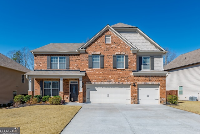 craftsman inspired home with a garage, concrete driveway, central AC unit, and brick siding