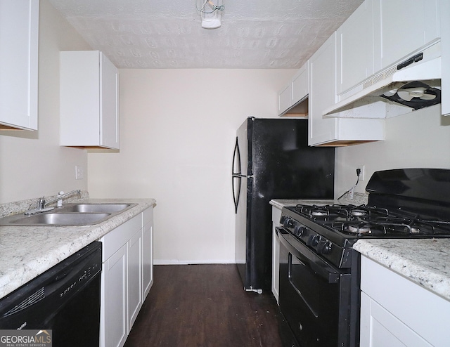 kitchen with white cabinets, dark wood-type flooring, under cabinet range hood, black appliances, and a sink