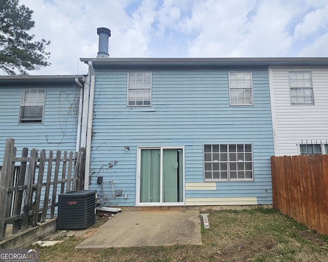 rear view of house featuring a patio area, fence, and central AC