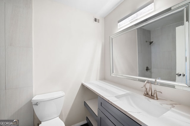 bathroom with toilet, visible vents, walk in shower, and vanity