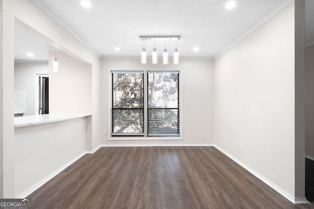 empty room featuring baseboards, recessed lighting, wood finished floors, and crown molding