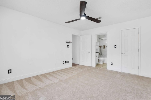 unfurnished bedroom with visible vents, baseboards, ensuite bath, ceiling fan, and carpet floors