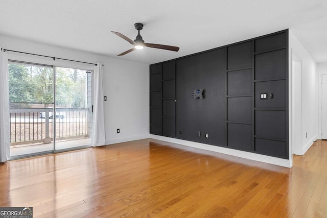 interior space with light wood-style floors, baseboards, and a ceiling fan