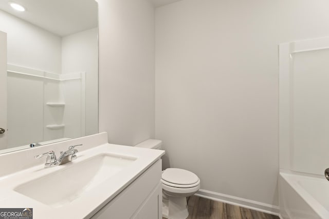 full bathroom with wood finished floors, toilet, vanity, a bathtub, and a shower