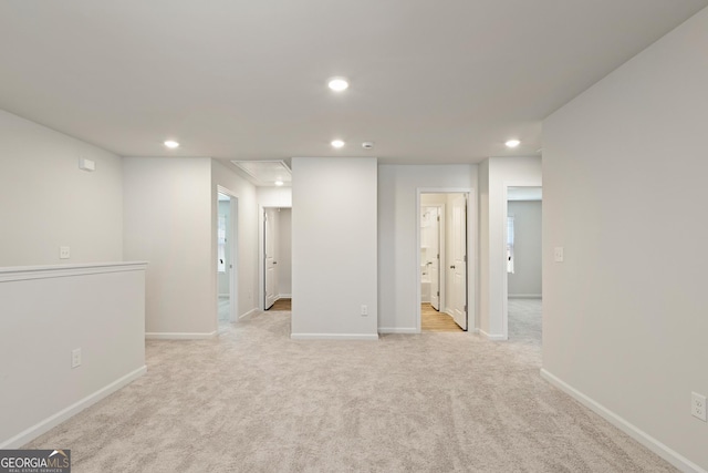 below grade area with recessed lighting, light colored carpet, and baseboards