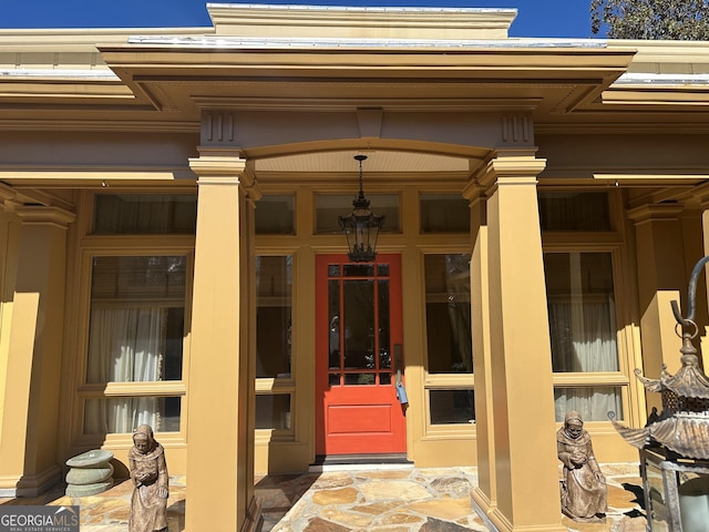 view of exterior entry with a porch