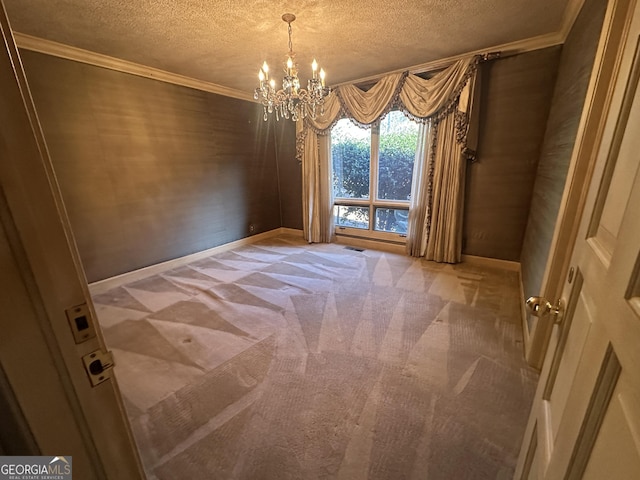 unfurnished room with carpet floors, a textured ceiling, a chandelier, and crown molding