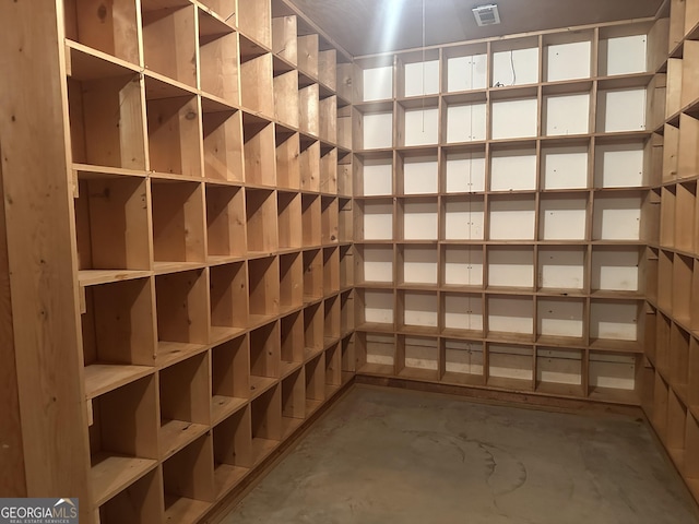 wine cellar featuring visible vents and unfinished concrete floors