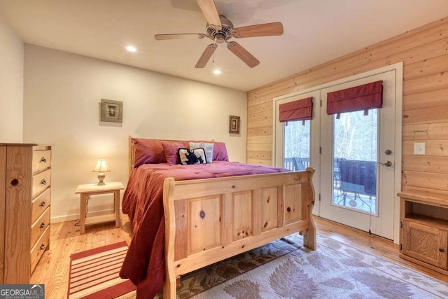 bedroom featuring ceiling fan, recessed lighting, wood walls, access to outside, and light wood-type flooring