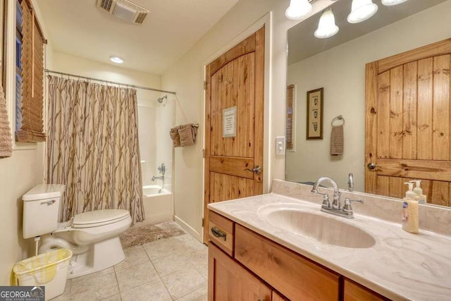 full bathroom with tile patterned flooring, toilet, vanity, visible vents, and shower / bath combo