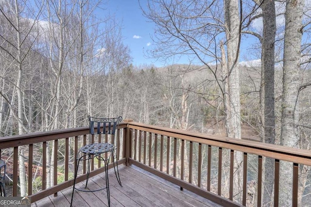 wooden deck featuring a wooded view