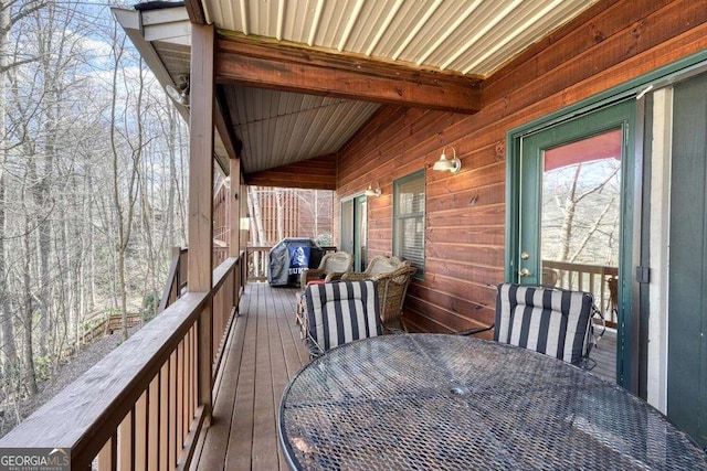 wooden terrace with outdoor dining space