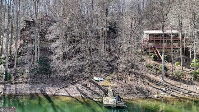 aerial view featuring a water view and a wooded view