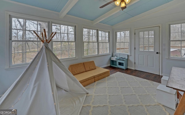 sunroom featuring vaulted ceiling with beams and a ceiling fan