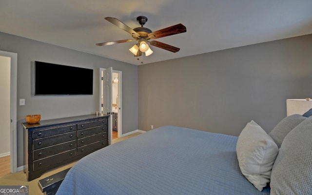 bedroom featuring a ceiling fan, baseboards, and ensuite bathroom