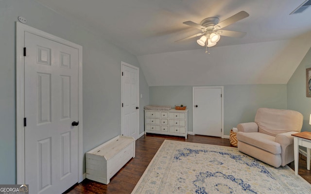 sitting room featuring lofted ceiling, ceiling fan, visible vents, and dark wood-style flooring