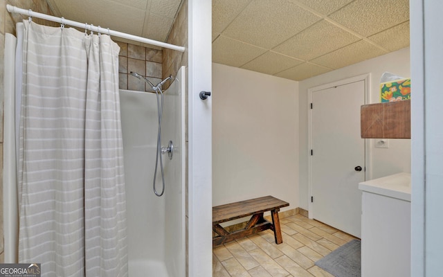 full bath with a paneled ceiling, a shower with shower curtain, and wood finished floors