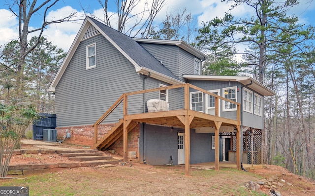 exterior space featuring stairs, a deck, cooling unit, and roof with shingles