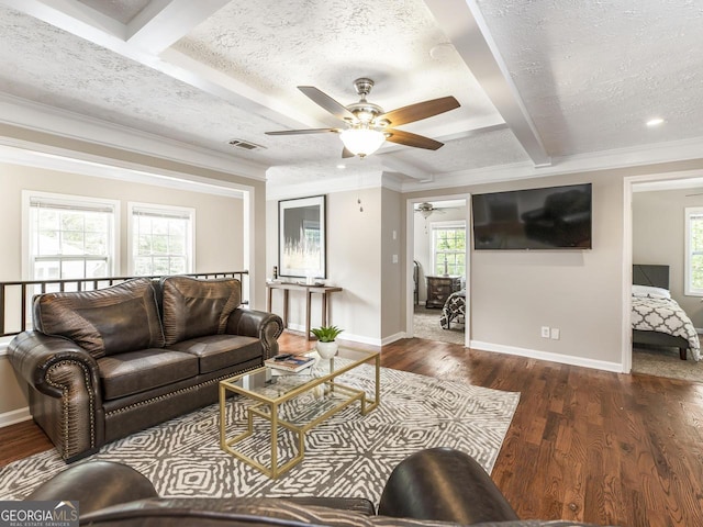 living area with baseboards, a textured ceiling, visible vents, and dark wood-type flooring