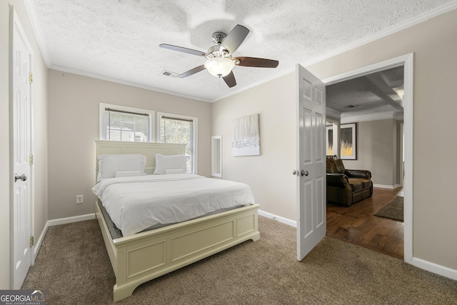 bedroom featuring visible vents, crown molding, a textured ceiling, and baseboards