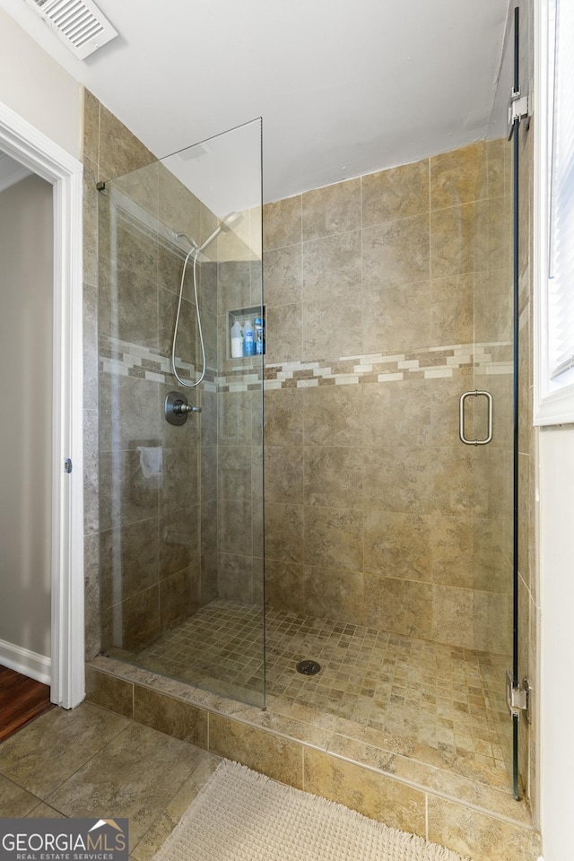 full bathroom with visible vents and a shower stall