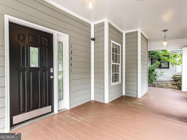 view of exterior entry with a porch