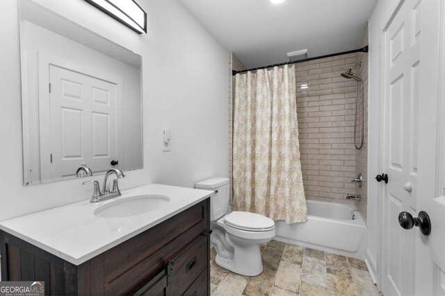 bathroom with toilet, shower / tub combo, and vanity