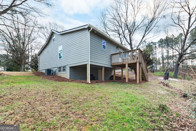 view of property exterior featuring a wooden deck, stairs, central AC unit, and a yard