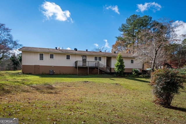 back of property with a lawn and central AC unit