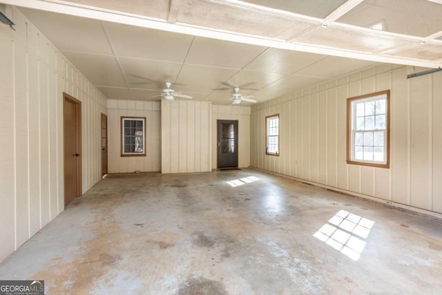 empty room with concrete flooring and a ceiling fan