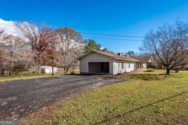 garage with aphalt driveway