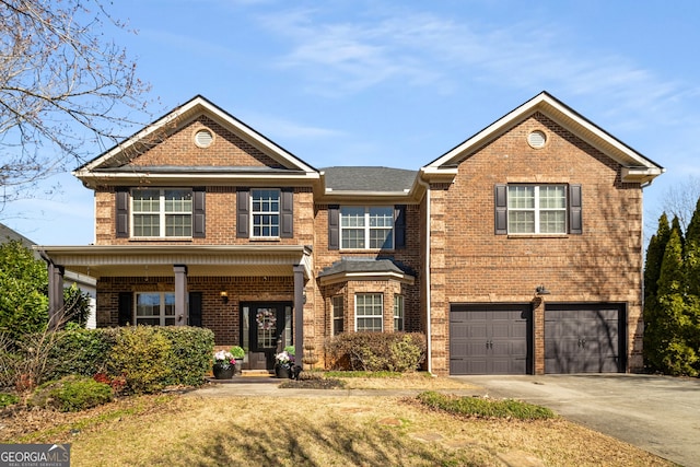 view of front of house featuring concrete driveway, brick siding, and an attached garage