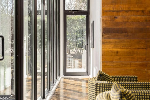 entryway featuring wood walls and wood finished floors