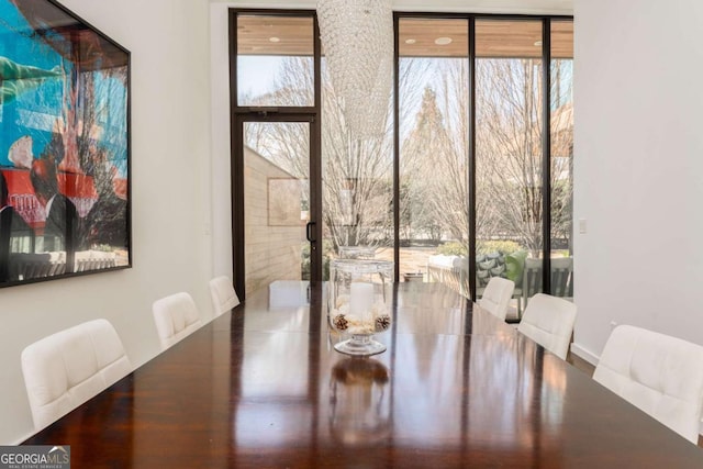 dining room with floor to ceiling windows and a wealth of natural light