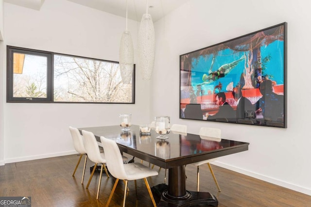 dining room with baseboards and wood finished floors